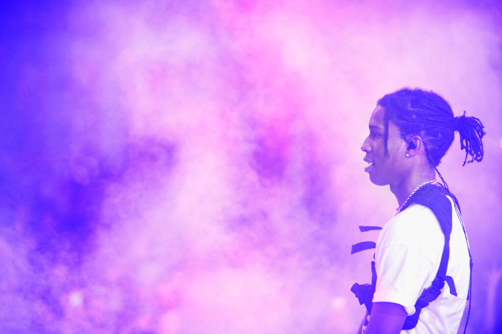 ASAP Rocky with a white shirt, there is purple smoke all around him