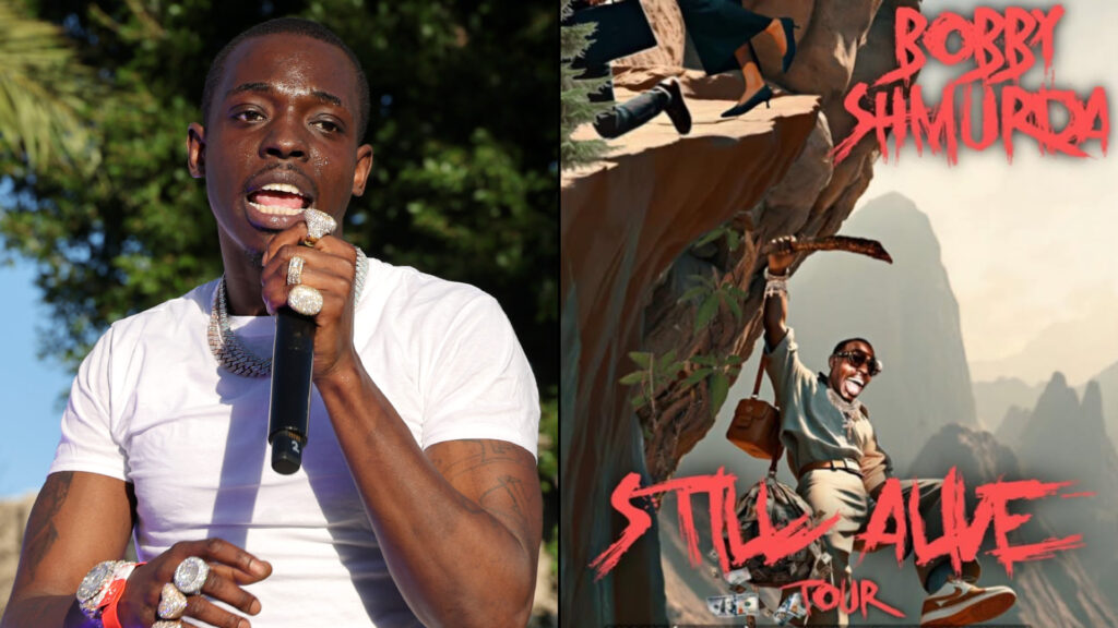 Bobby Shmurda in a white shirt holding a microphone performs outdoors, with trees in the background.