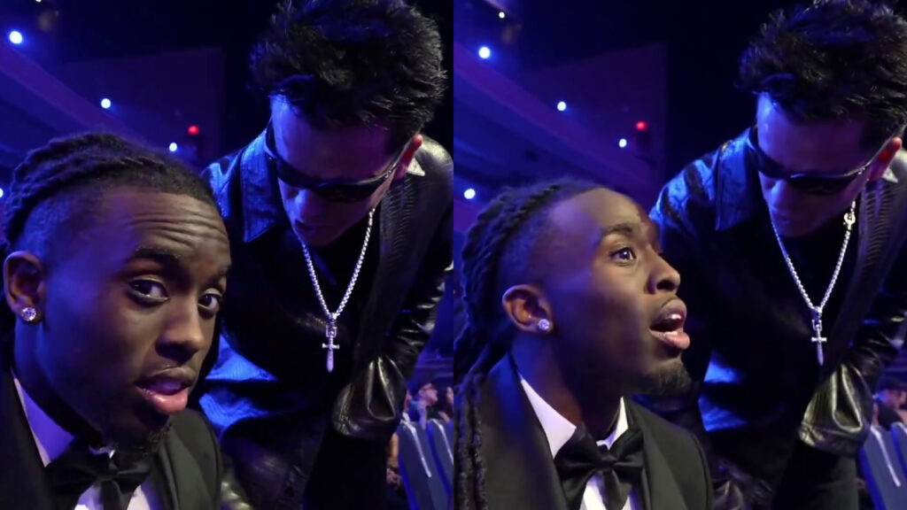 Kai Cenat Calls Out Pro–Kanye West Fan for Crashing His A… Kai Cenat in a black tuxedo and bow tie stands against a purple background, looking to the side and smiling.