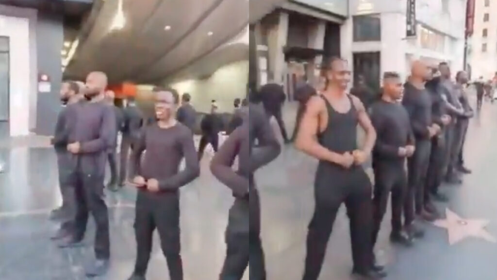 The artist formerly Kanye West in a black jacket stands outdoors, looking serious.