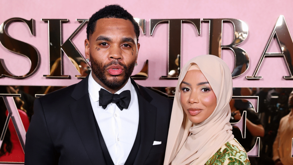 Brittany Renner Confirms Divorce from Kevin Gates After 5… A man in a tuxedo and a woman in a beige hijab pose together at an event with a pink backdrop.