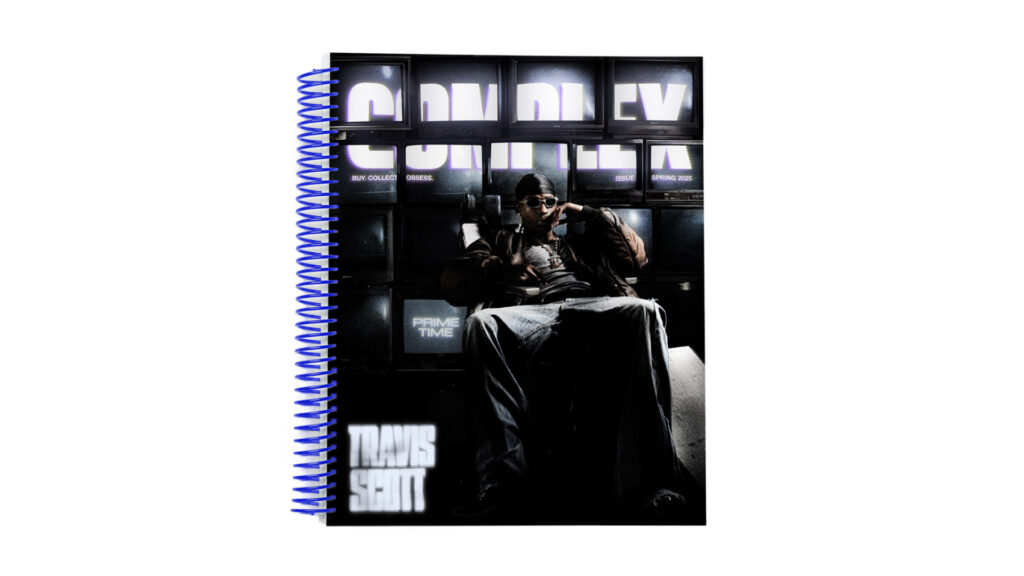 Travis Scott on a Complex magazine cover, sitting in a chair with sunglasses, surrounded by screens. Blue spiral binding on the side.