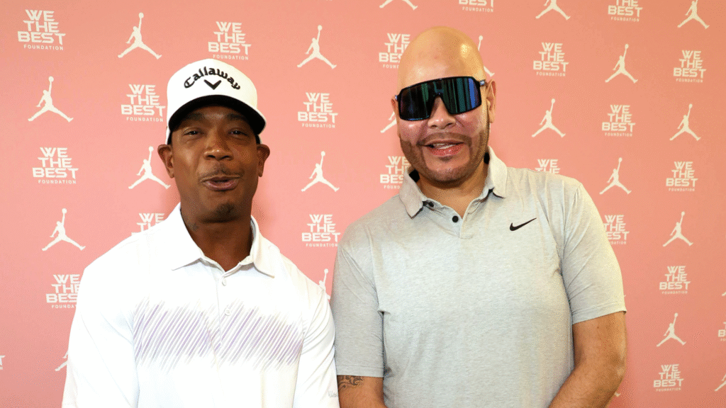 Ja Rule and Fat Joe posing in front of a "We The Best" Foundation backdrop, both smiling.
