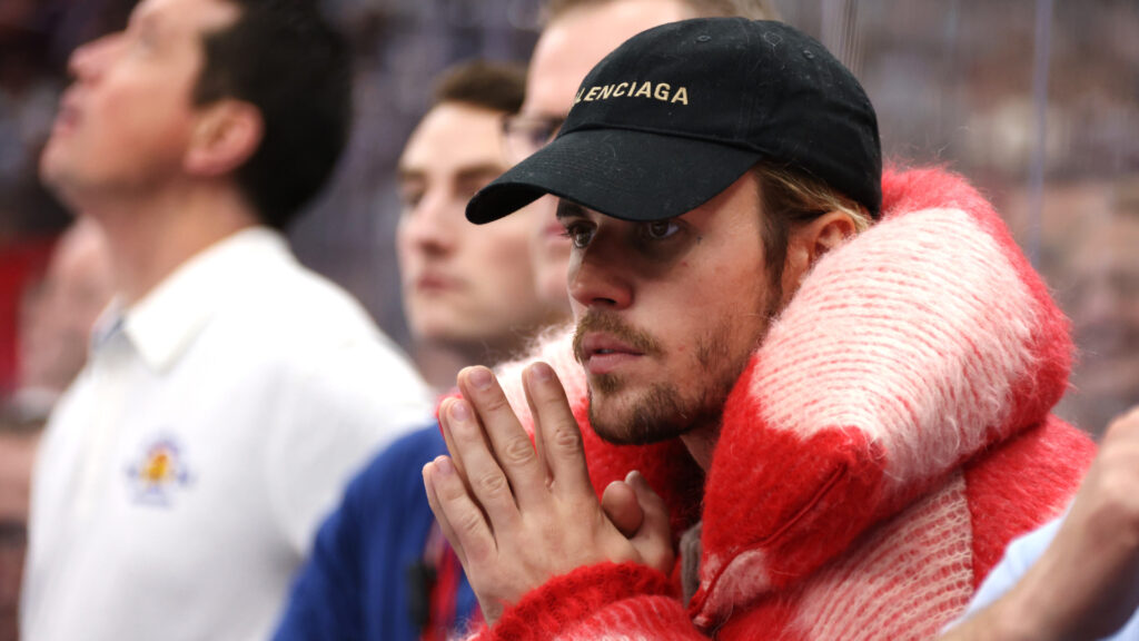 Justin Bieber on People Telling Him to Heal: ‘I Know I’m … Justin Bieber wearing a Balenciaga cap and a red and white striped jacket, looking focused in a crowd.