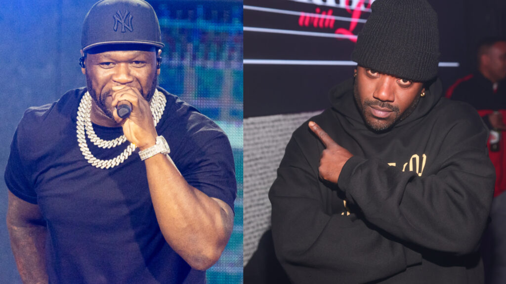 50 Cent performing in a black shirt and cap, holding a mic. Ray J posing with crossed arms in a black hoodie and beanie.