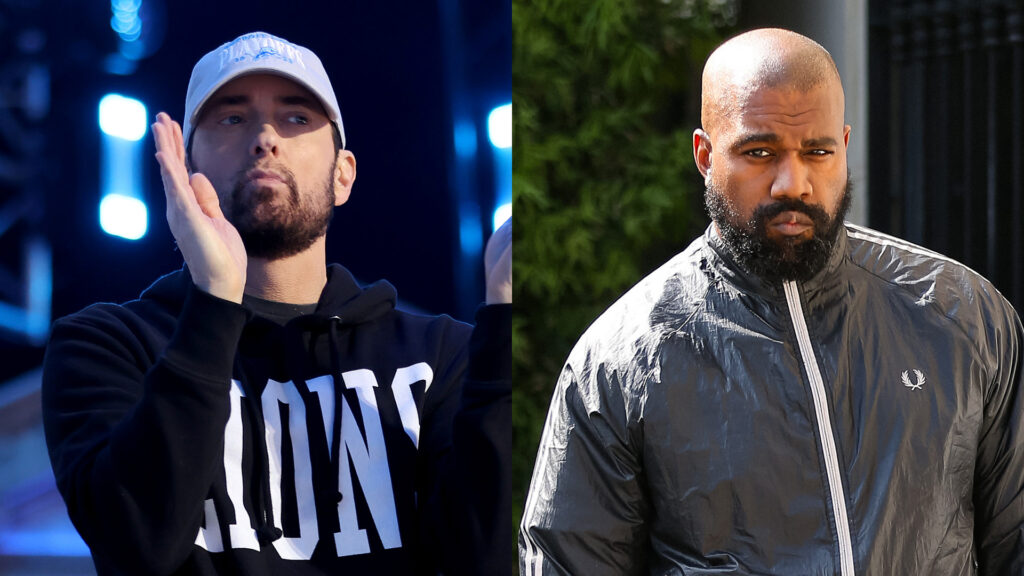 Eminem clapping in a black hoodie and cap, and Kanye West in a black jacket, looking serious.