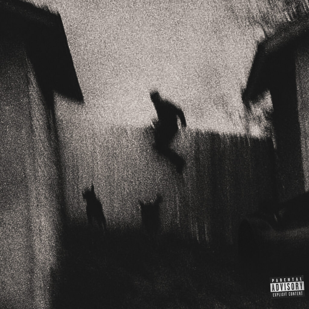 A grainy, black and white image of a person jumping over a fence with two dogs nearby. Parental advisory label in the corner.